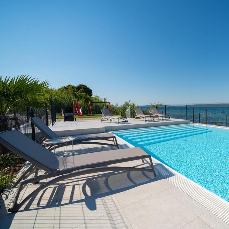 Shared beachfront swimming pool at Camping Nevia