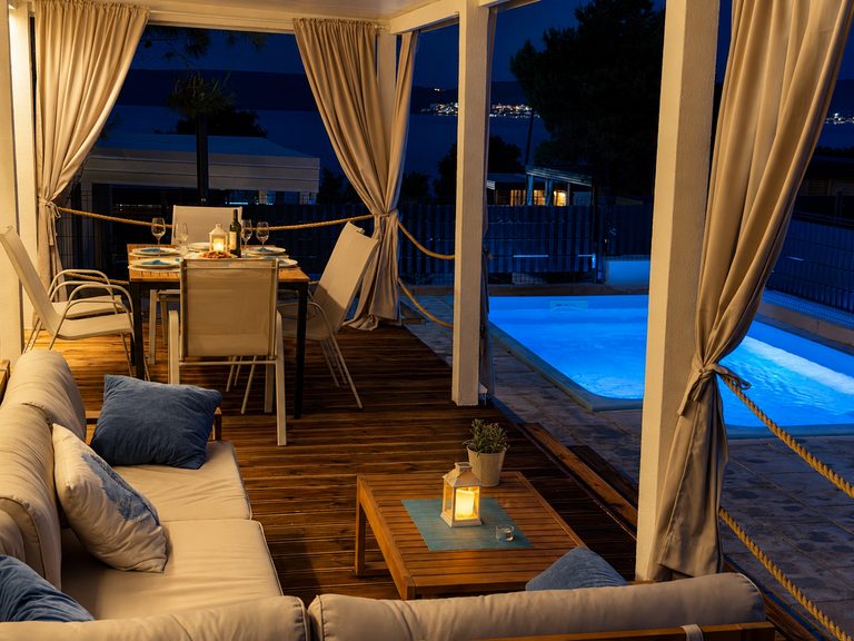 Covered terrace and private pool at Salvia Beachside Homes in the evening