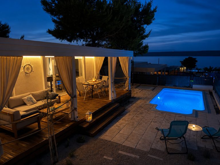 Private pool at Salvia Beachside Homes illuminated at night