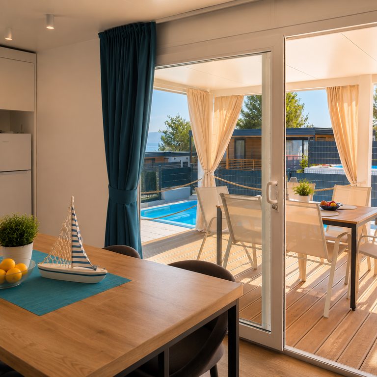 Dining area opening onto the covered terrace and private pool at Salvia Beachside Homes