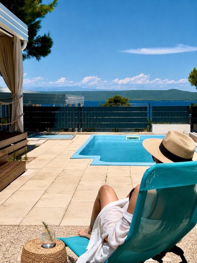 Guest relaxing beside the private pool at Salvia Beachside Homes