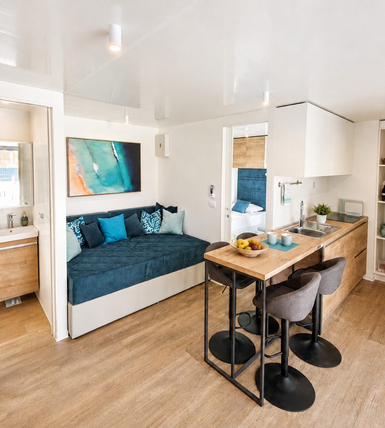 Bright open-plan living and dining area with built-in seating and a dining table